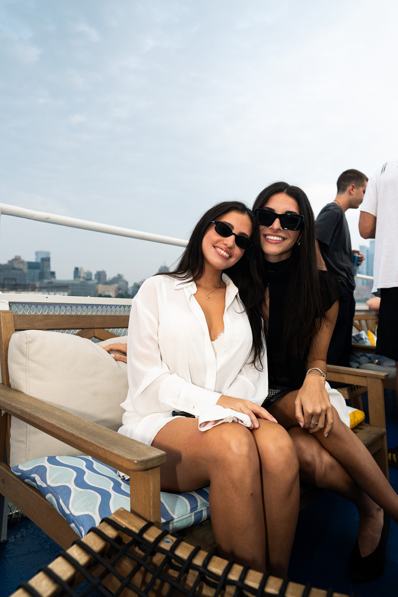 Guests enjoying a private corporate cruise on the Hudson with the NYC skyline behind them